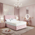 Pink bedroom with tufted headboard, chandelier, and vanity table.

Narjis Divan Bed detail - Premium fabric divan handcrafted in the UK