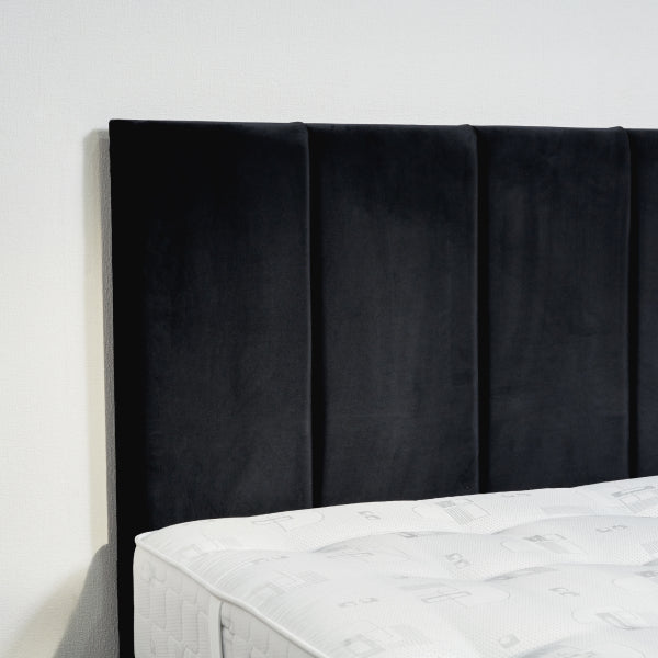Black upholstered headboard on a bed with white bedding against a white wall

Osaka Divan Bed detail - Premium UK-made divan with mattress options