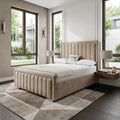 Modern bedroom with a beige upholstered bed, wooden nightstands, and large windows.