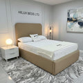 Bedroom with a bed and nightstand, featuring 'Hilux Beds Ltd.' branding.