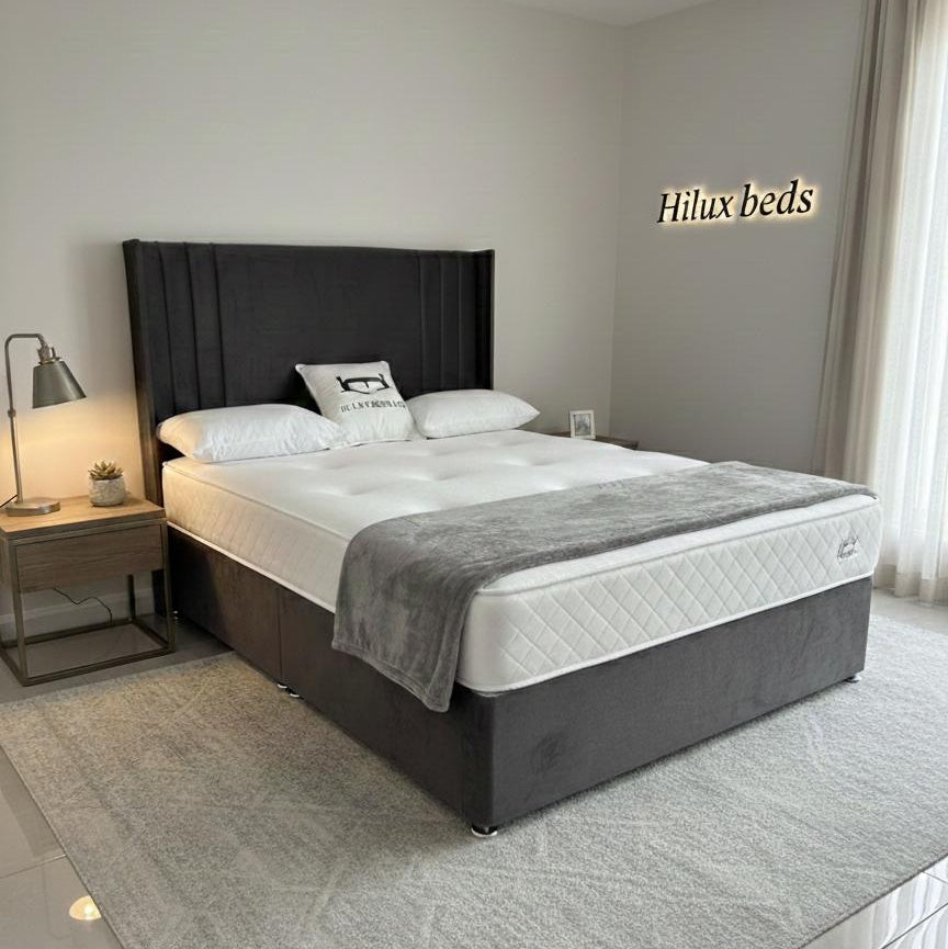 Bedroom with a bed and nightstands, featuring the brand 'Hilux beds'.