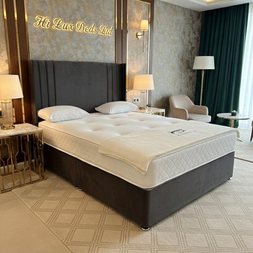 Bedroom with a large bed and decorative headboard, featuring the brand 'Hi Lux Beds Ltd'.
