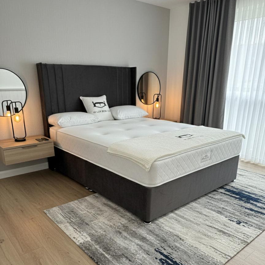 Bedroom with a bed featuring a mattress and pillows, wooden flooring, and decorative elements.