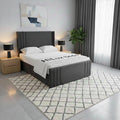 Modern bedroom with a gray upholstered bed, nightstands, and lamps.