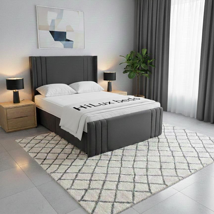 Modern bedroom with a gray upholstered bed, nightstands, and lamps.