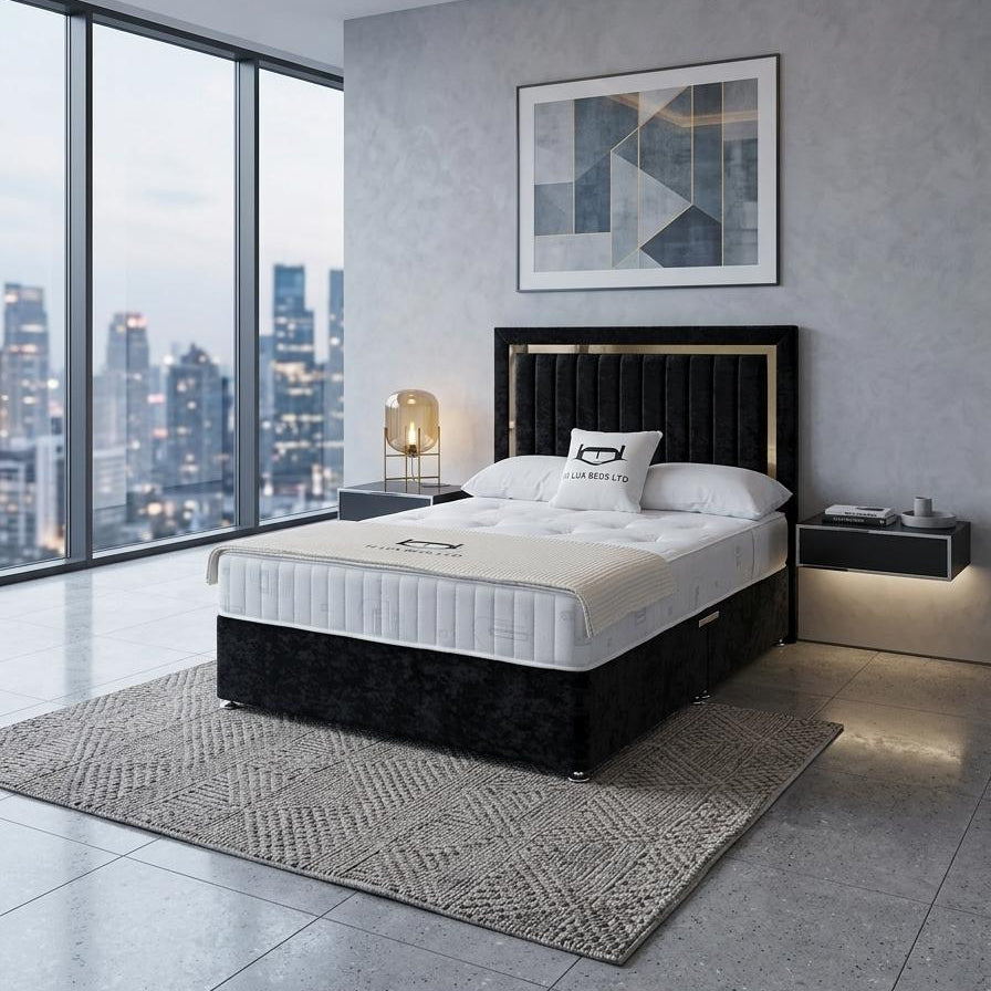 Modern bedroom with a black bed frame and white mattress, cityscape view through window.