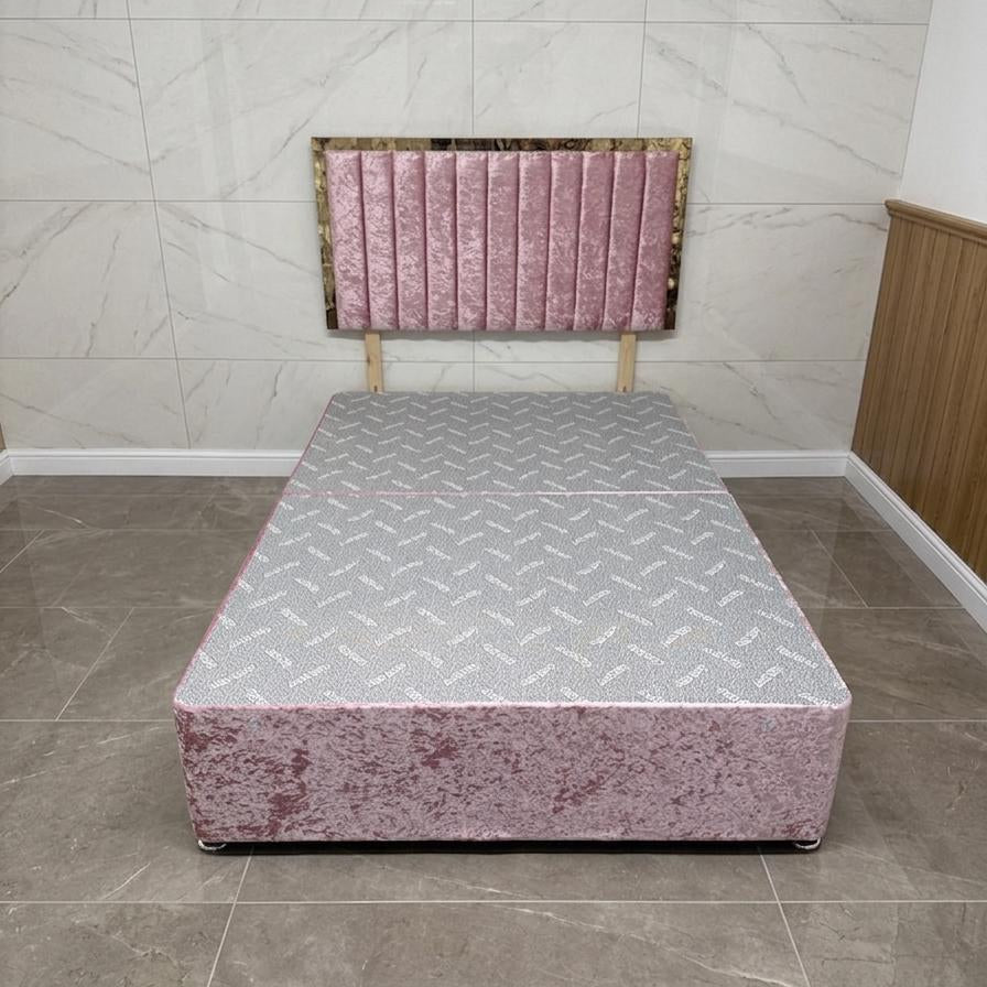 Pink bed with a patterned headboard on a tiled floor.