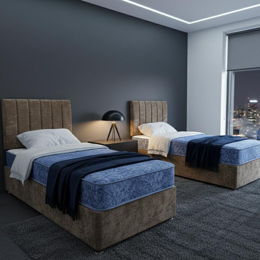 Modern bedroom with two beds, nightstands, and a cityscape view.