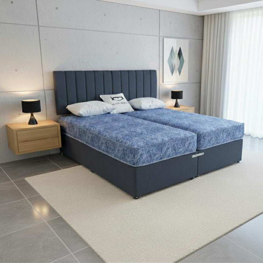 Modern bedroom with a blue bed and wooden nightstands.