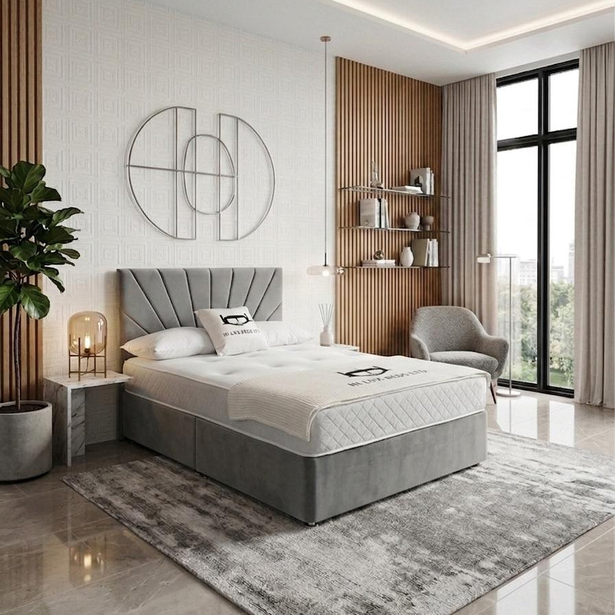 Modern bedroom with gray upholstered bed, side table, and armchair.