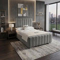 Modern bedroom with gray upholstered bed, nightstands, and abstract wall art.
