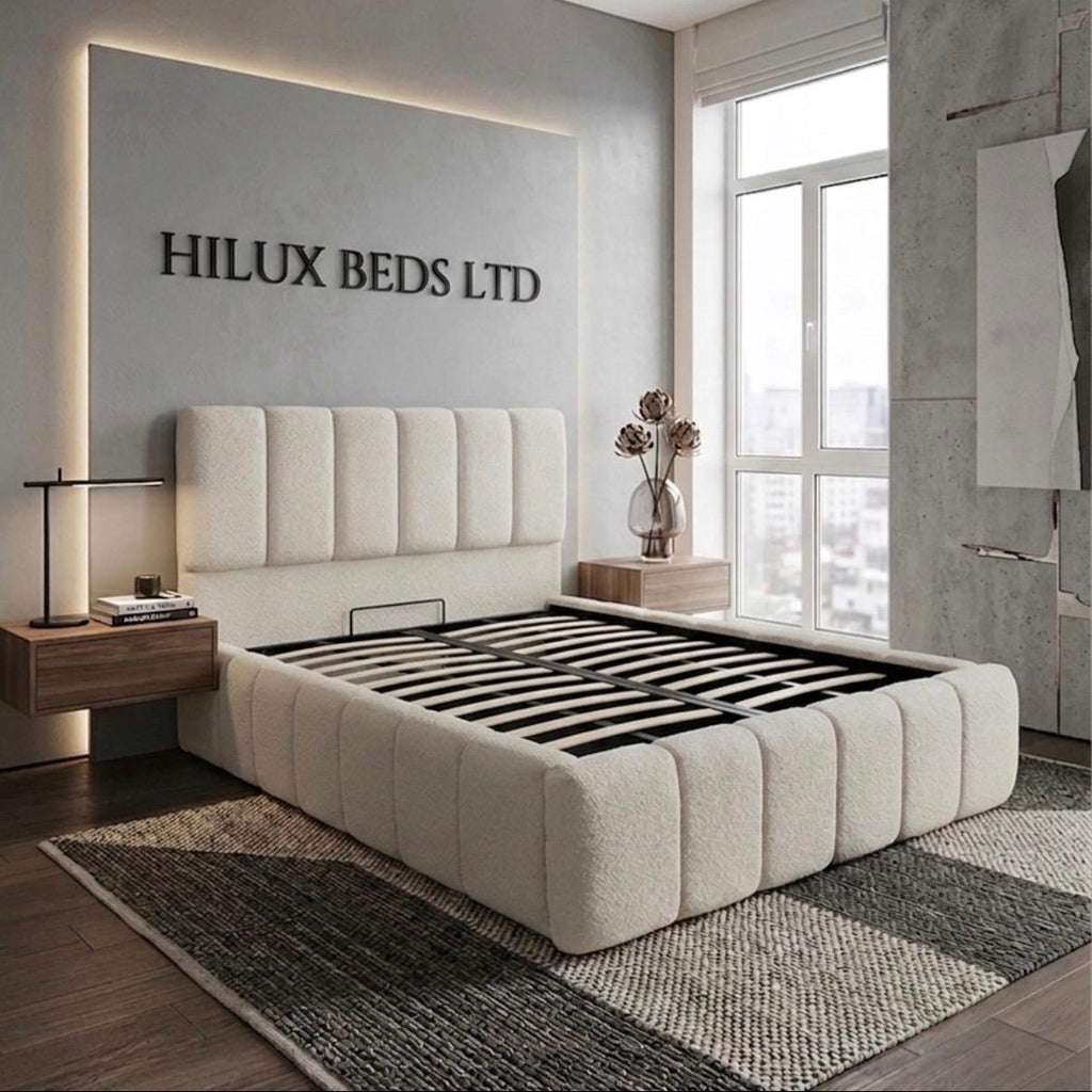 Modern bedroom with a large bed and 'Hilux Beds Ltd' branding on the wall.