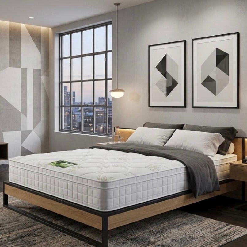 Modern bedroom with a bed, nightstands, and wall art.