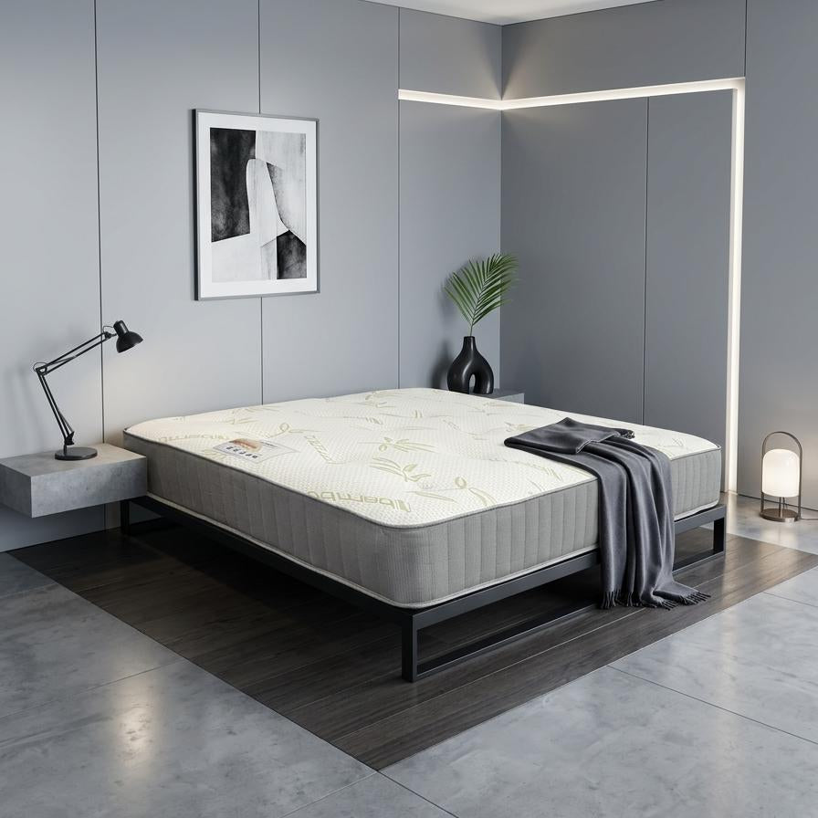 Modern bedroom with a bed and decorative elements on a gray tiled floor.