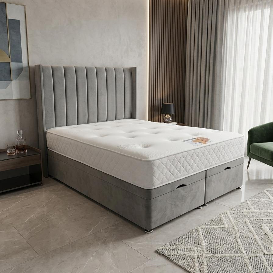 Gray upholstered bed with white mattress in a modern bedroom setting.
