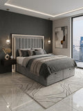 Modern bedroom with gray upholstered bed, nightstands, and abstract art on a cityscape.