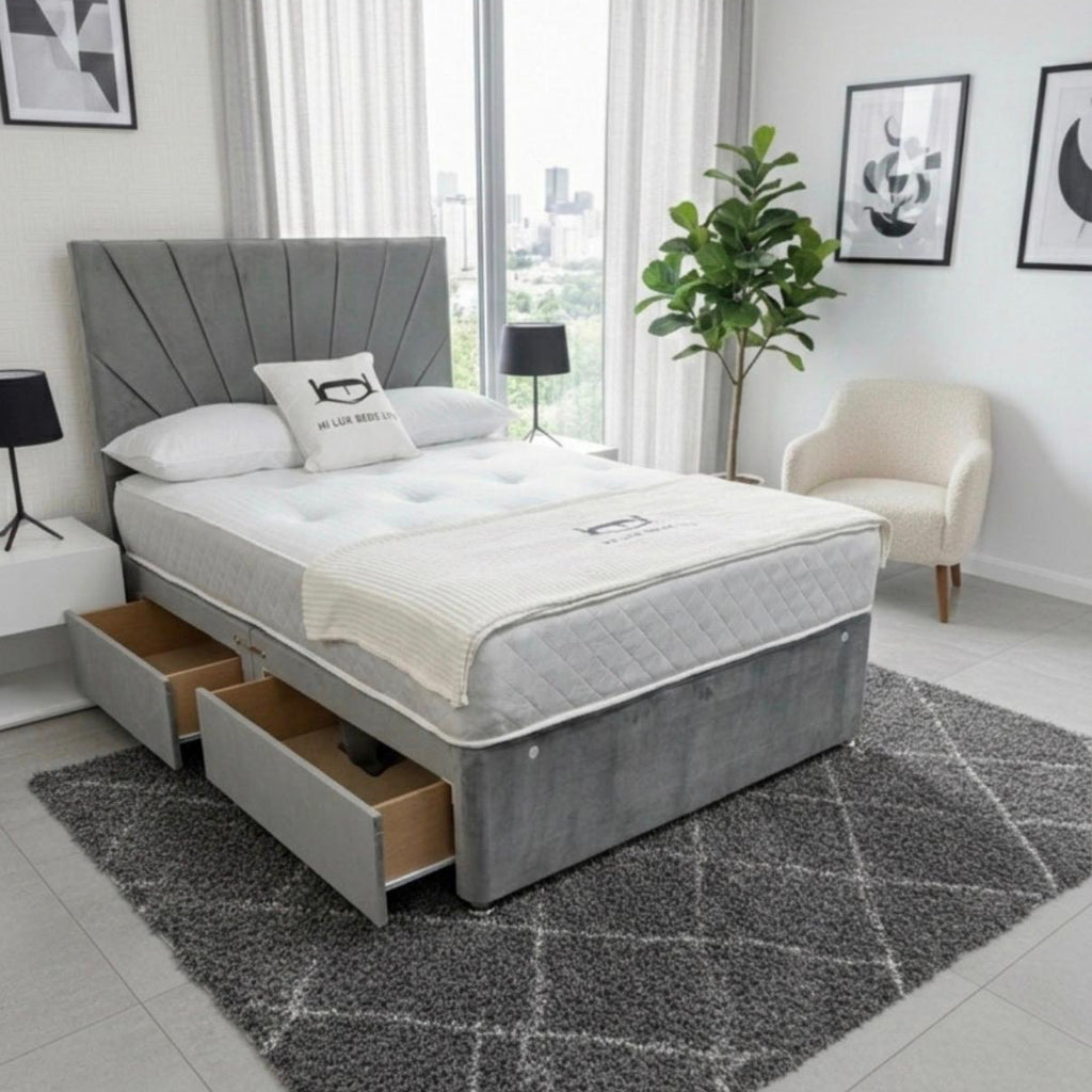 Gray upholstered bed with storage drawers in a modern bedroom setting.