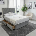 Gray upholstered bed with storage drawers in a modern bedroom setting.