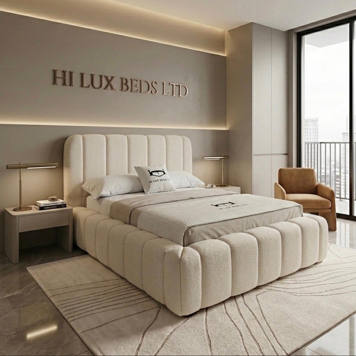 A luxury upholstered bed in a modern beige bedroom, featuring a segmented tufted headboard and matching footboard. The room includes a matching beige armchair, bedside tables with lamps, and a large window with a view of a city skyline.