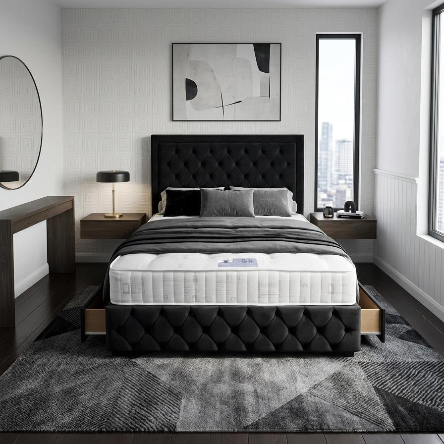 A modern bedroom featuring a black tufted platform bed frame with a white mattress, styled with gray bedding, flanked by matching bedside tables and a gray patterned area rug.