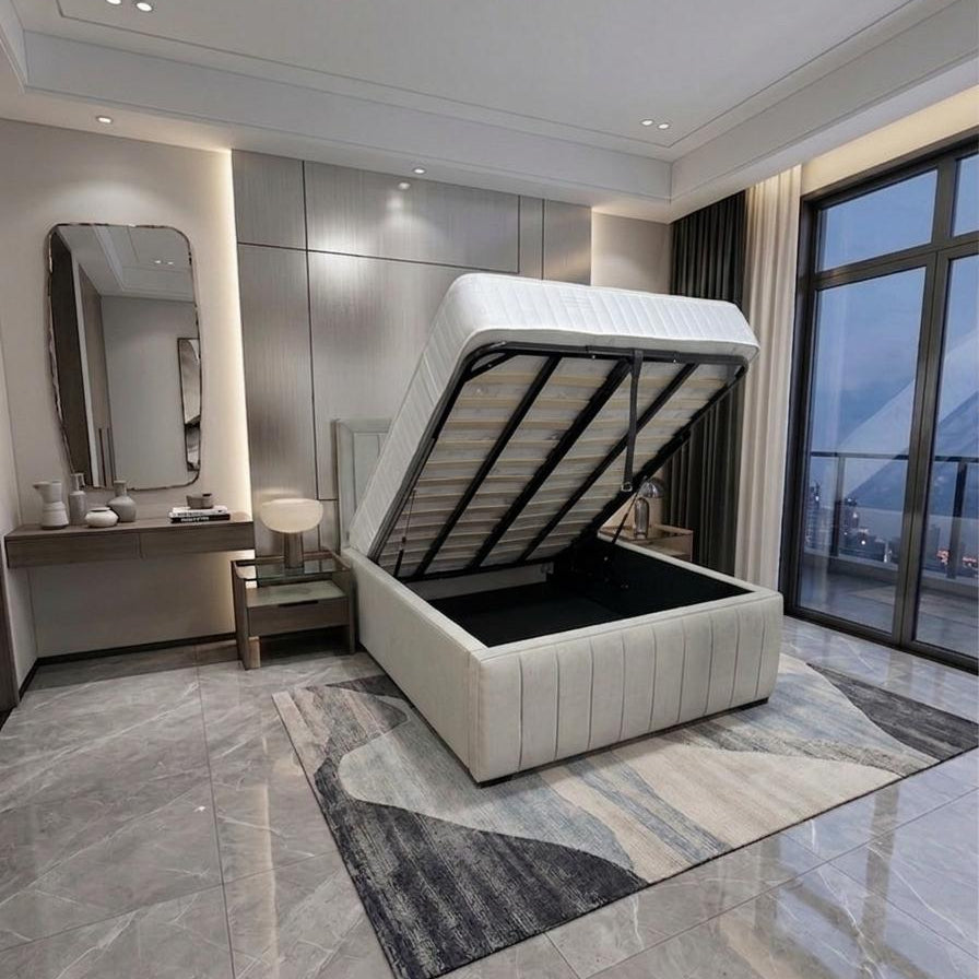 A modern lift-up platform bed with a white upholstered frame and black interior storage compartment, shown in a contemporary bedroom setting with gray marble flooring and a patterned rug.