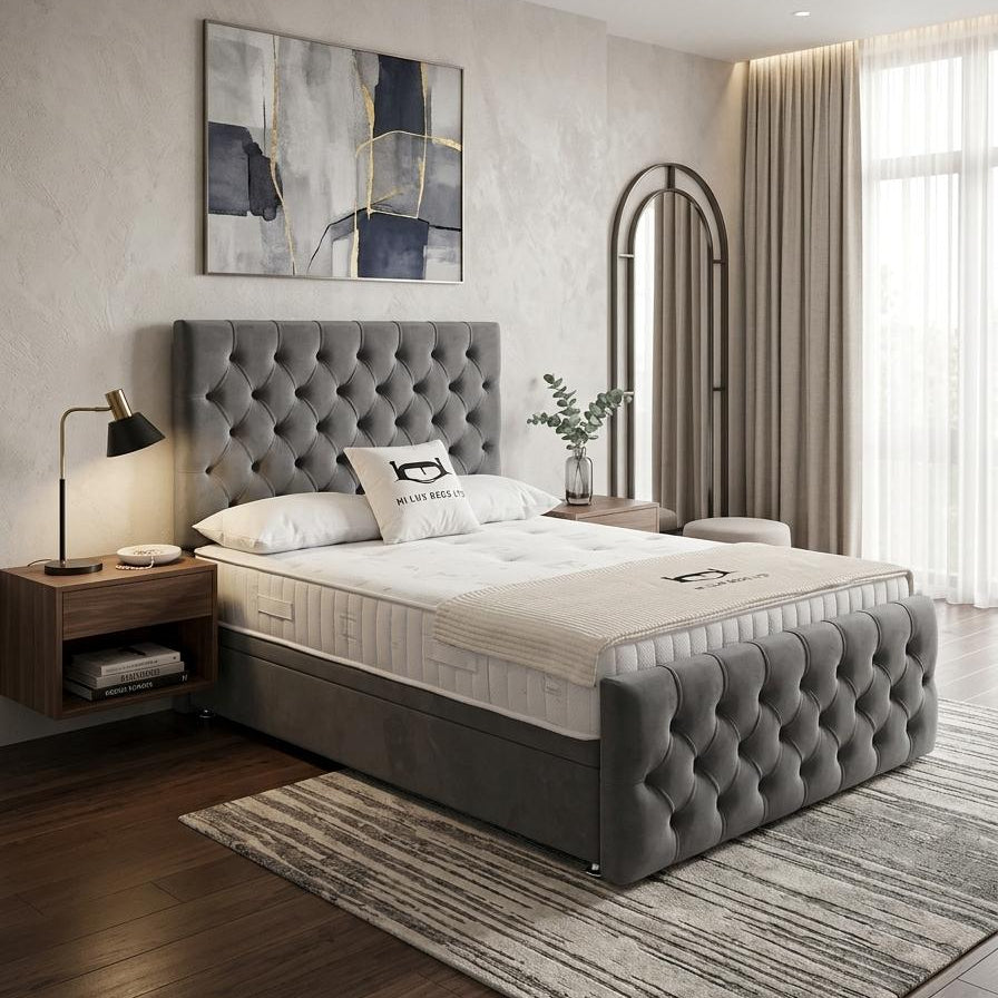 A modern bedroom featuring a gray tufted upholstered bed frame with a mattress, styled with a wooden nightstand, black desk lamp, abstract wall art, and a striped area rug.