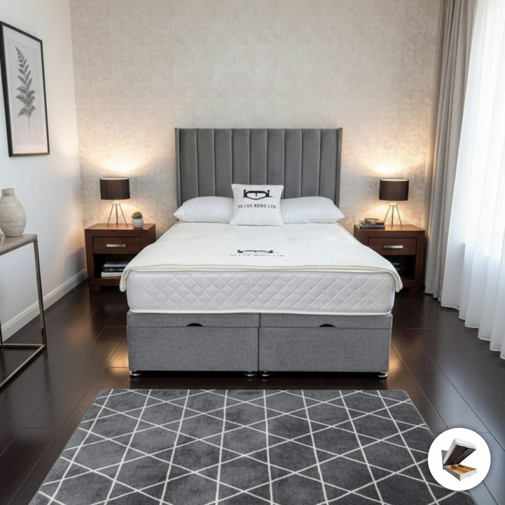 Gray upholstered bed with white mattress in a bedroom setting.