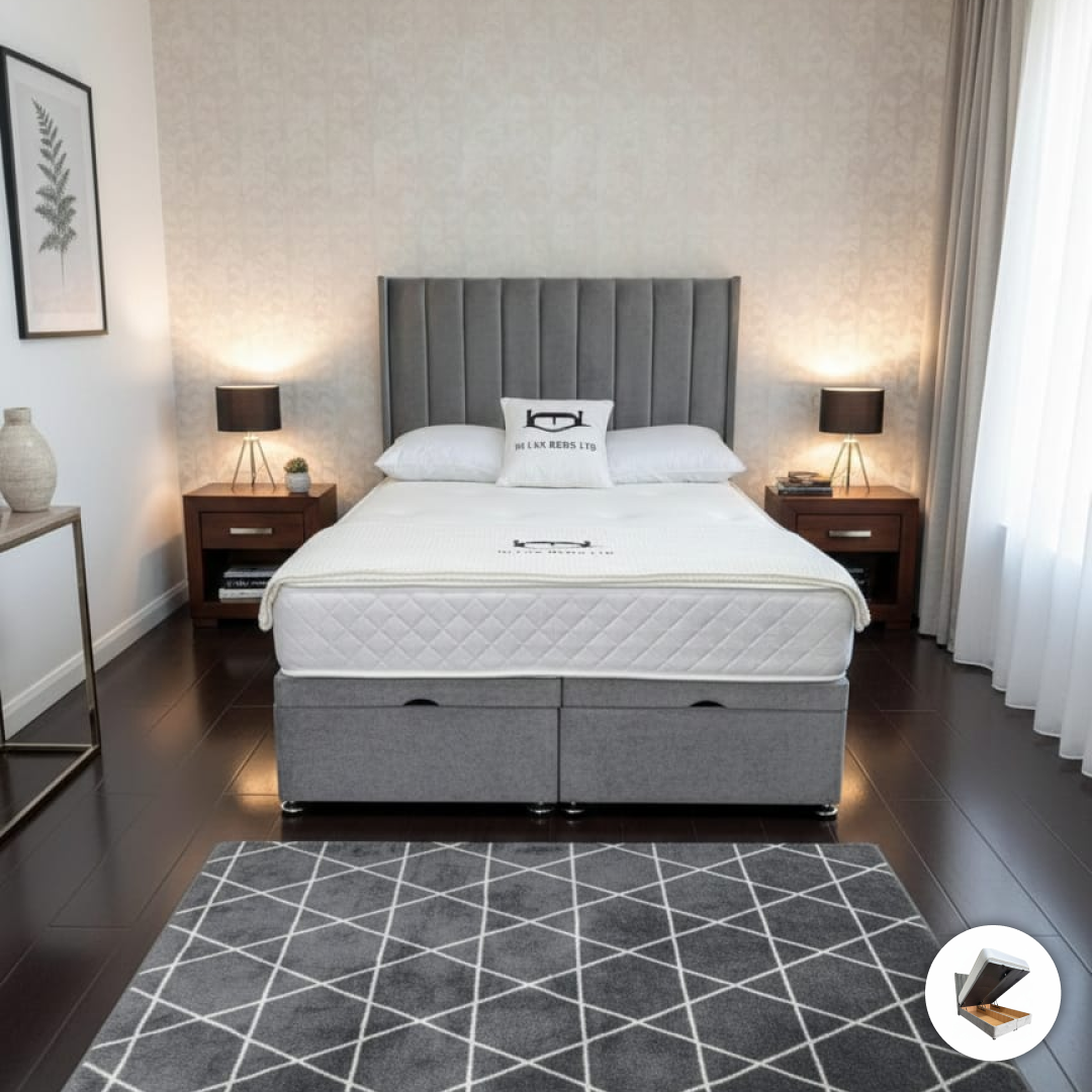 Gray upholstered bed with white mattress in a bedroom setting.